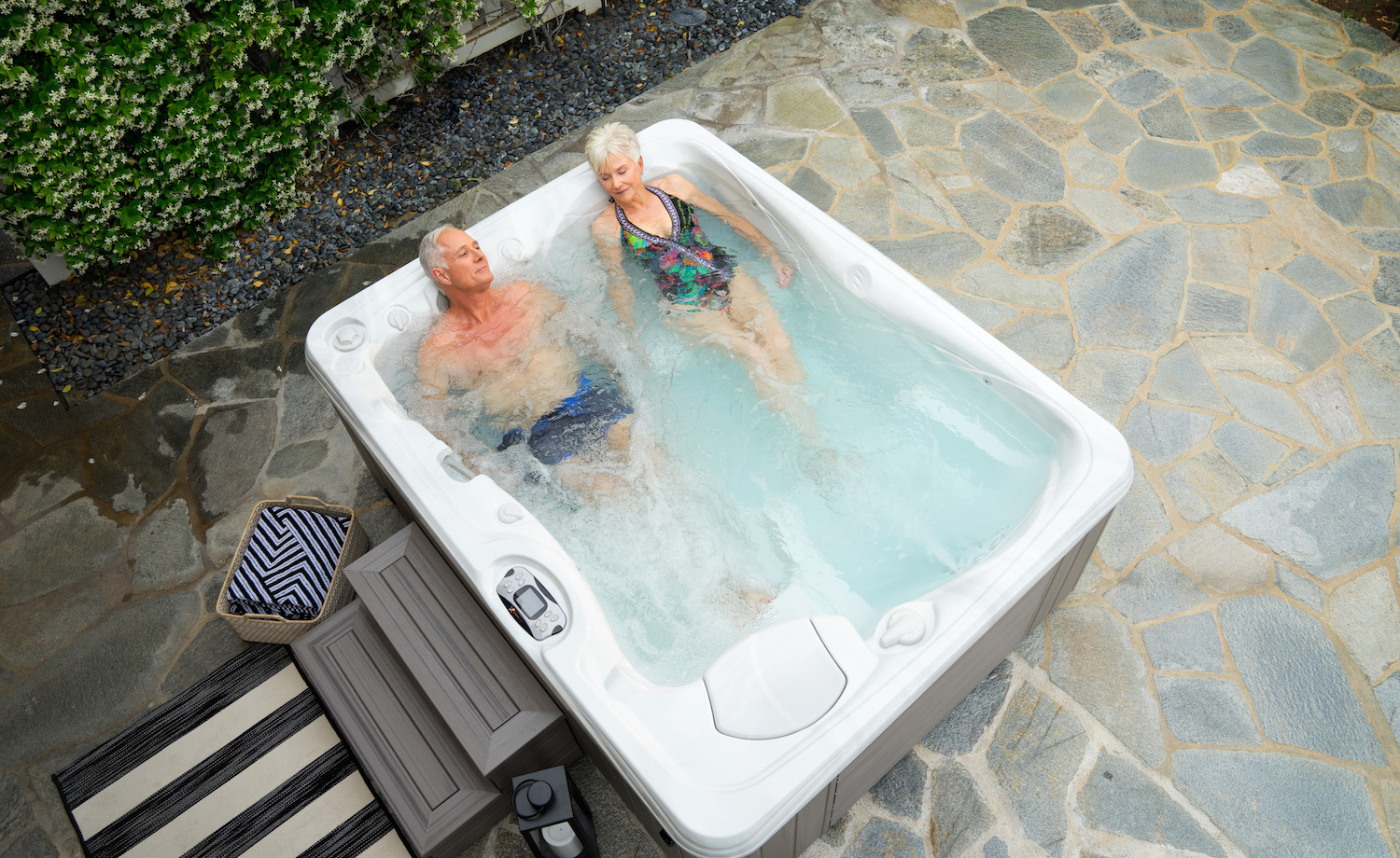 https://www.calderaspas.com/wp-content/uploads/2018/04/Caldera-Paradise-Kauai-Hot-Tub-Sterling-Marble-Coastal-Gray-Lifestyle-Couple-012.jpg