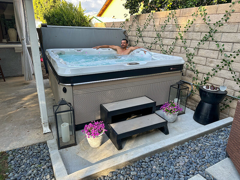 Tiana Masaniani's husband, Eddie, enjoys a soothing soak in their Caldera Spa backyard hot tub.