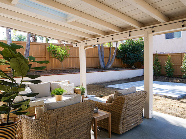 A cozy and inviting outdoor patio with a covered seating area.