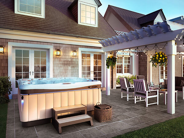 A luxurious backyard retreat featuring a hot tub, perfect for relaxation and entertaining guests.